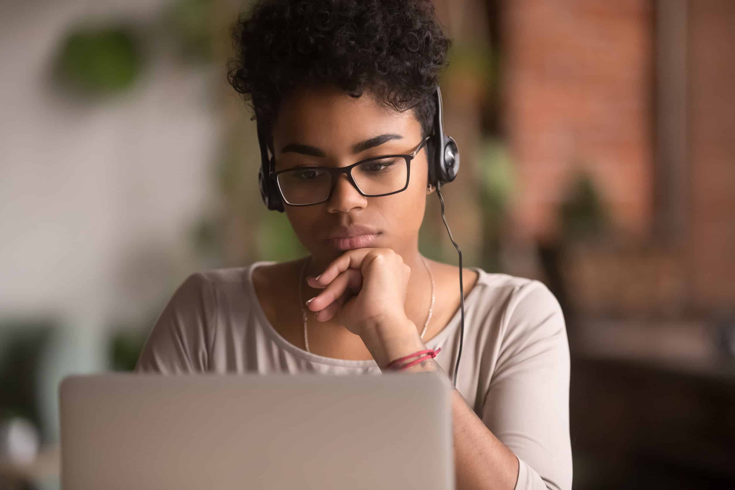 Woman listening to podcast at computer